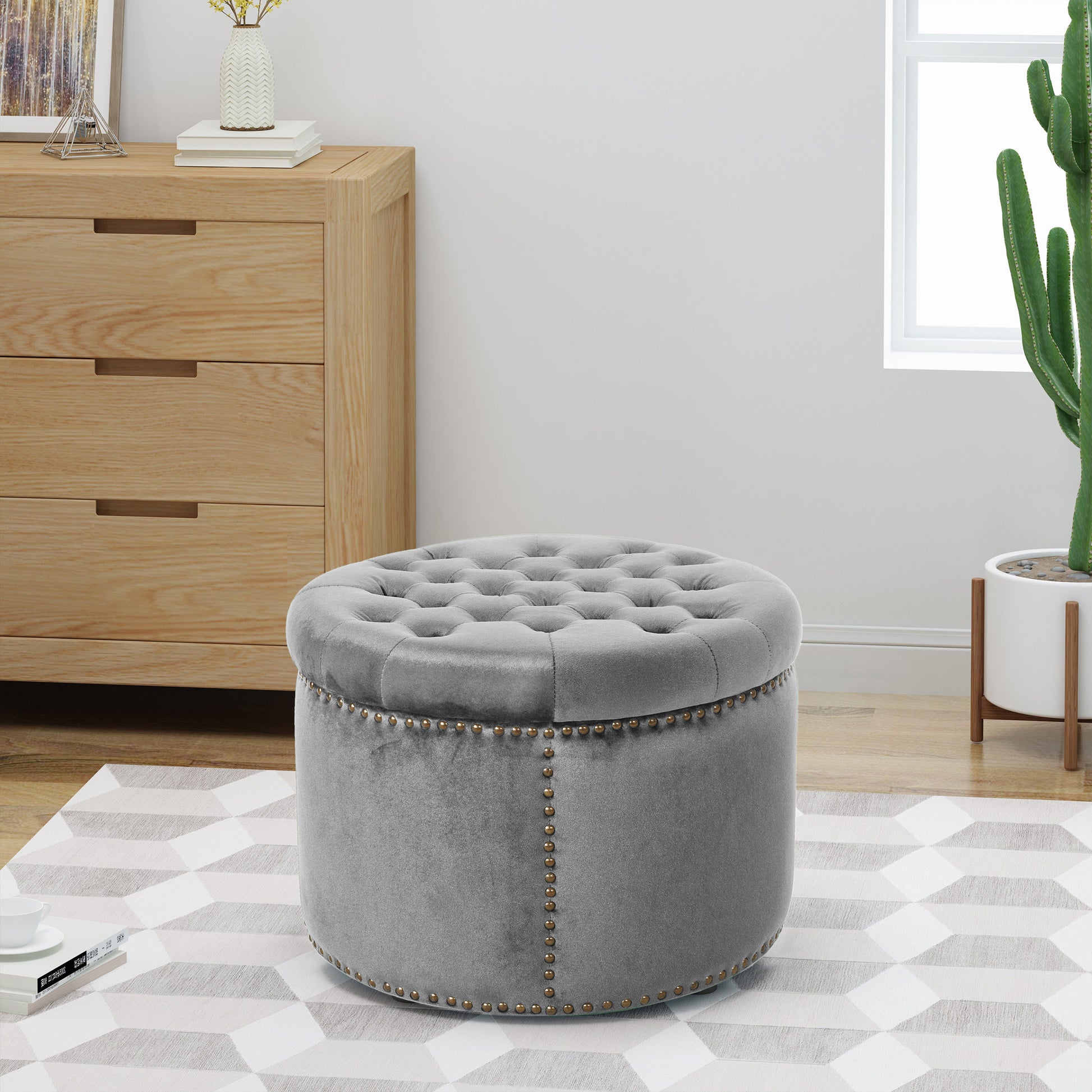Tufted grey velvet ottoman with brass nailhead trim perfect for footrest