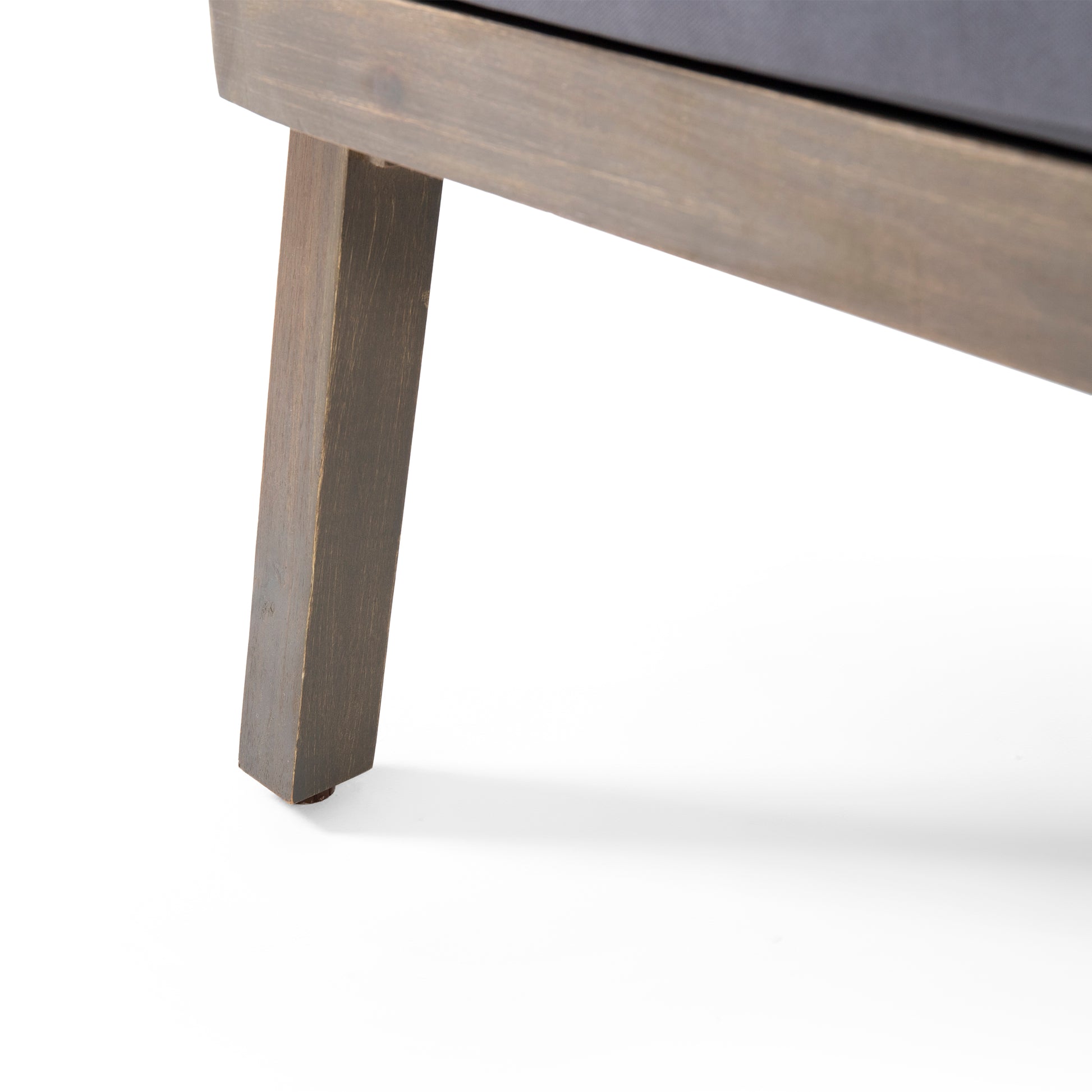 Dark stained wood patio lounge chair leg detail on white background