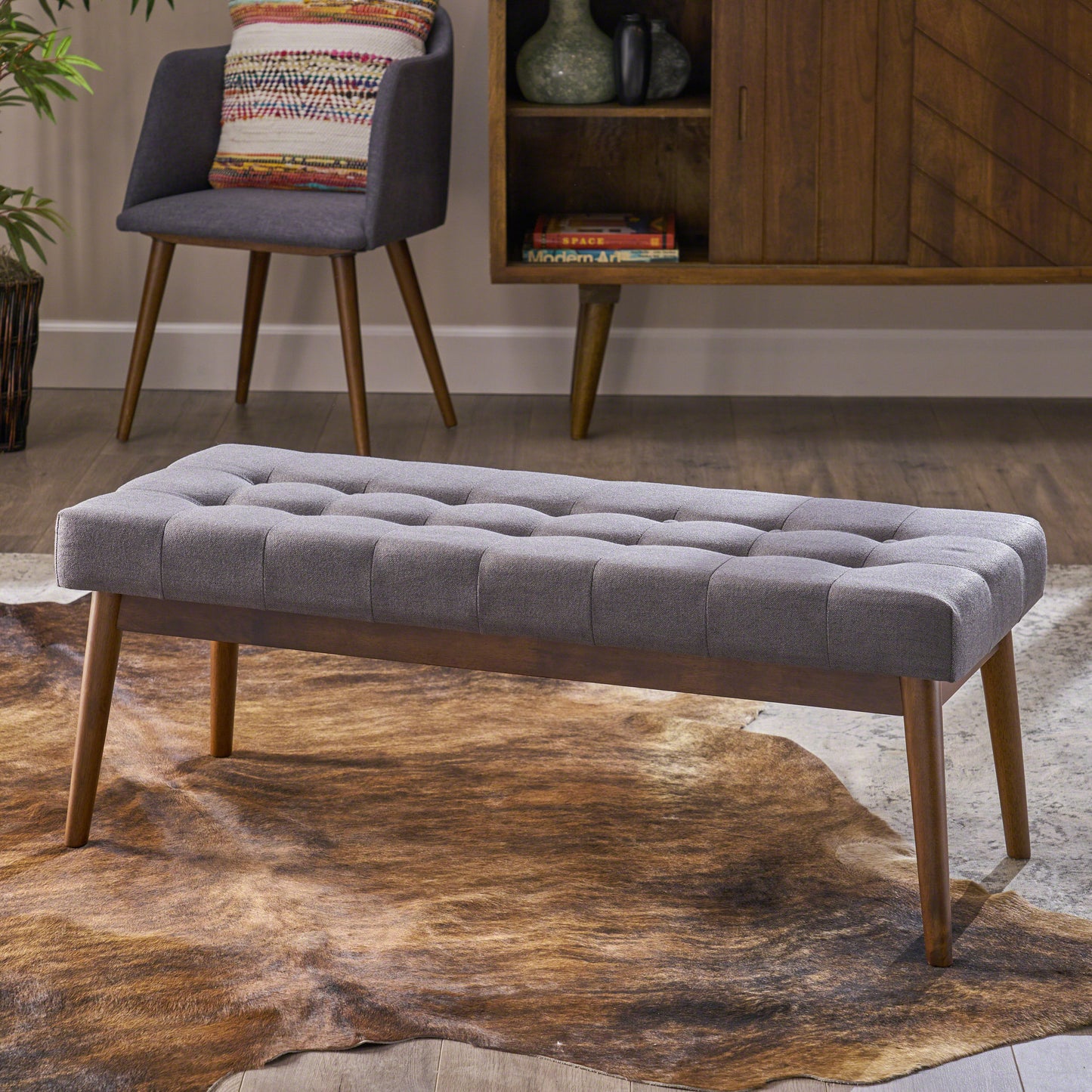 Tufted grey upholstered bench with wooden legs ideal for entryways or living rooms