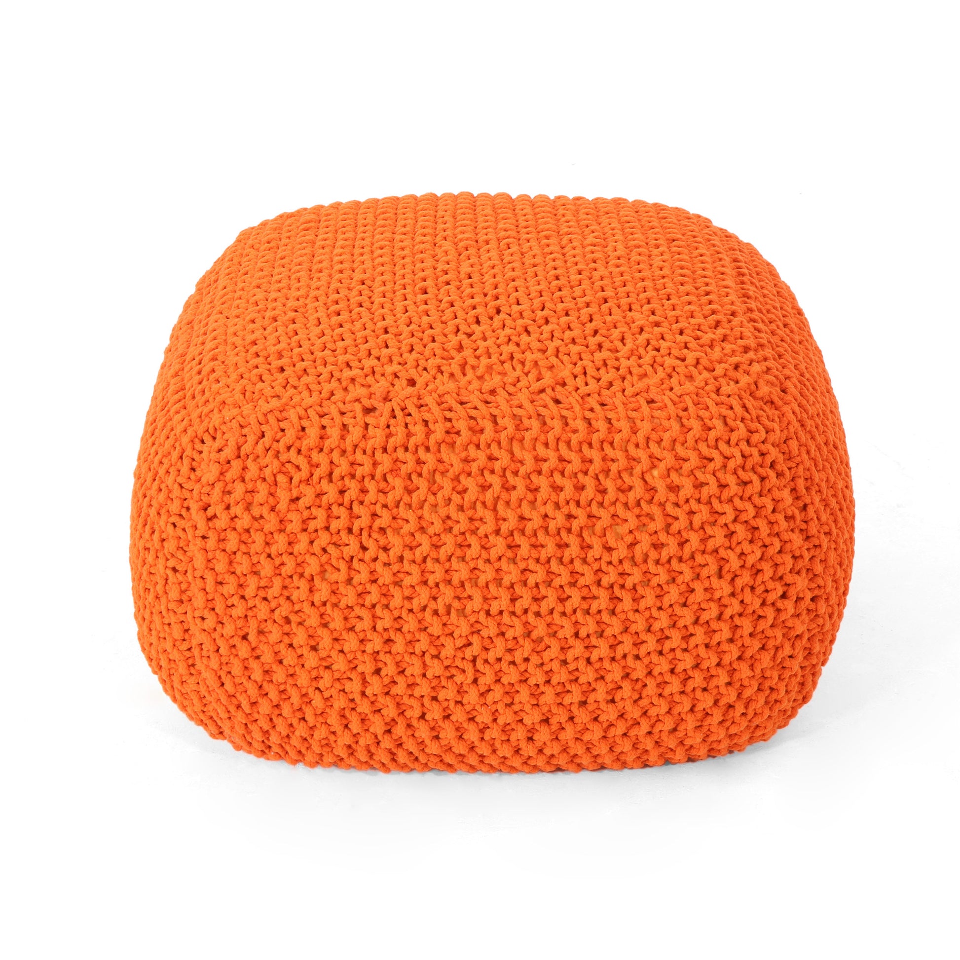 Orange knit floor pouf with thick yarn texture adding warmth and color to any room