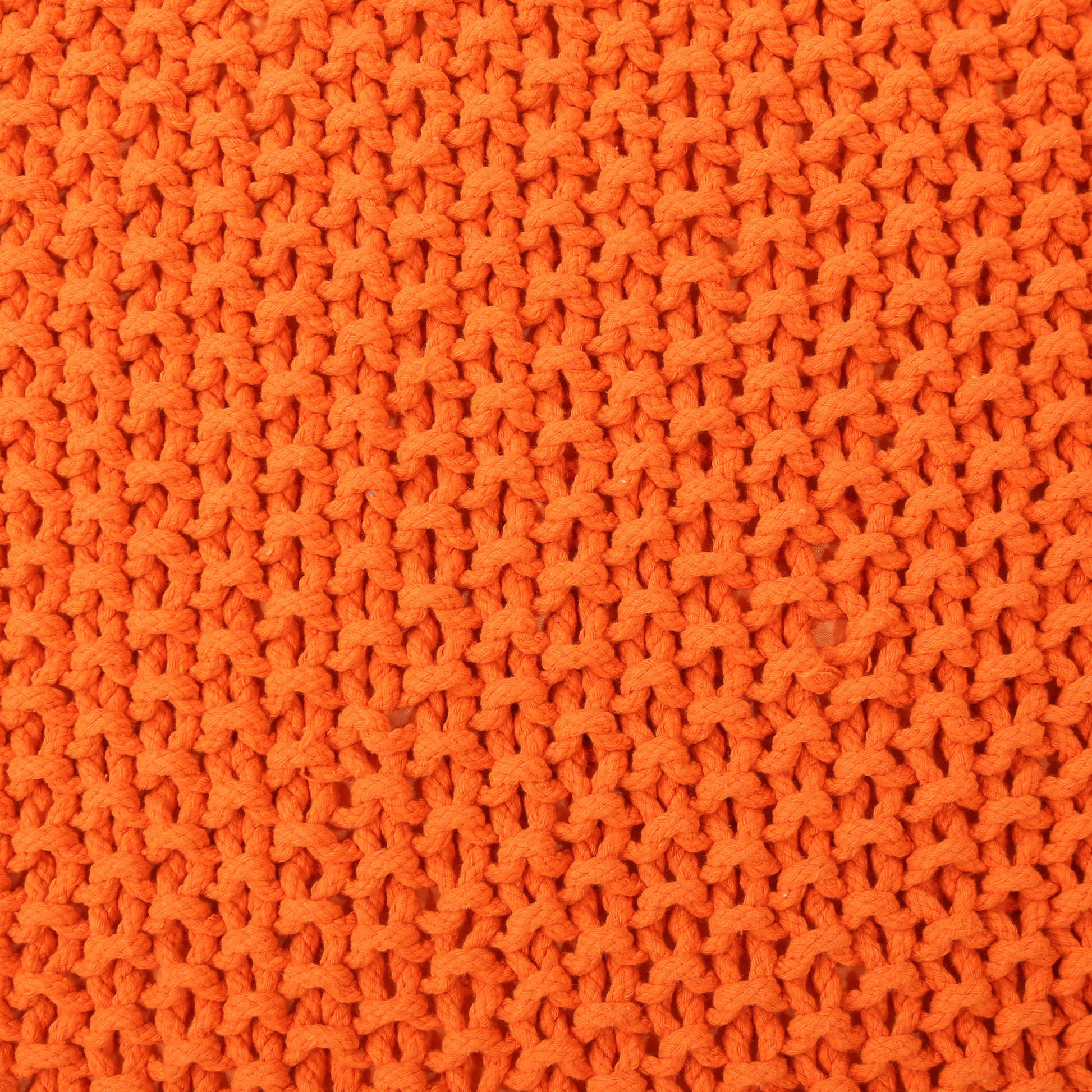 Closeup of bright orange chunky knit fabric showcasing textured yarn loops