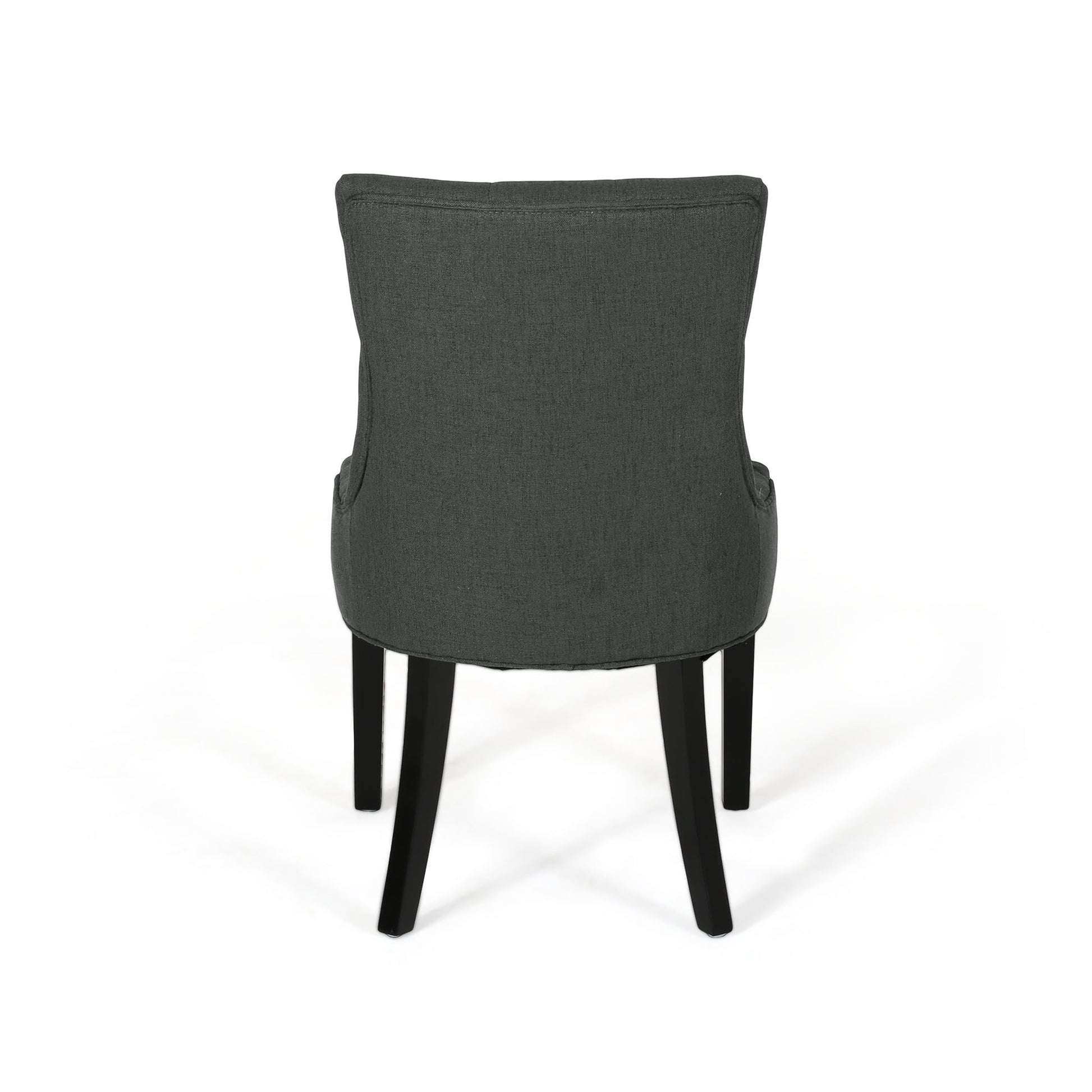 Dark gray upholstered dining chair with button tufting and black legs