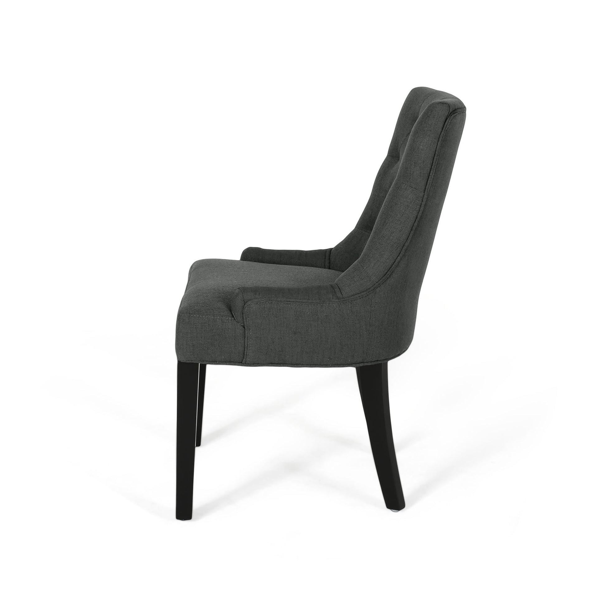 Dark grey upholstered dining chair with tufted back and black legs