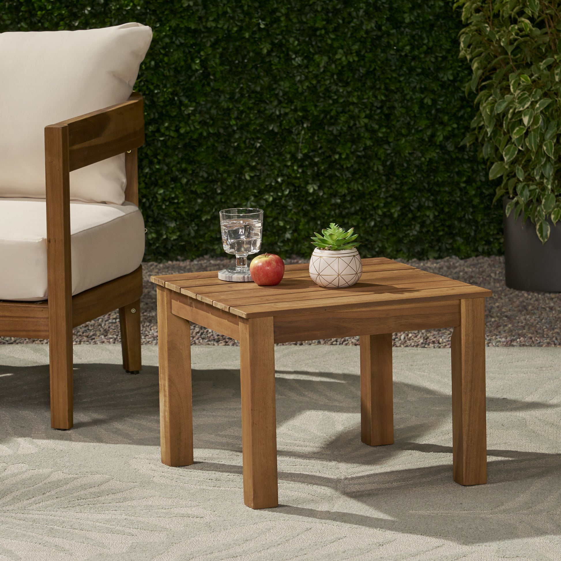 Square wood side table with slatted top and thick legs ideal for patio use