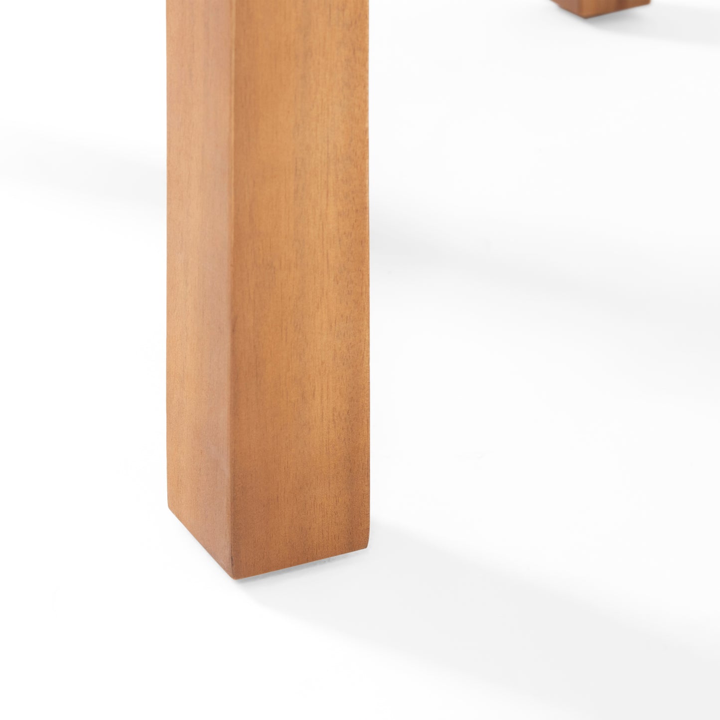Solid acacia wood table leg in a warm honey finish showcasing natural grain