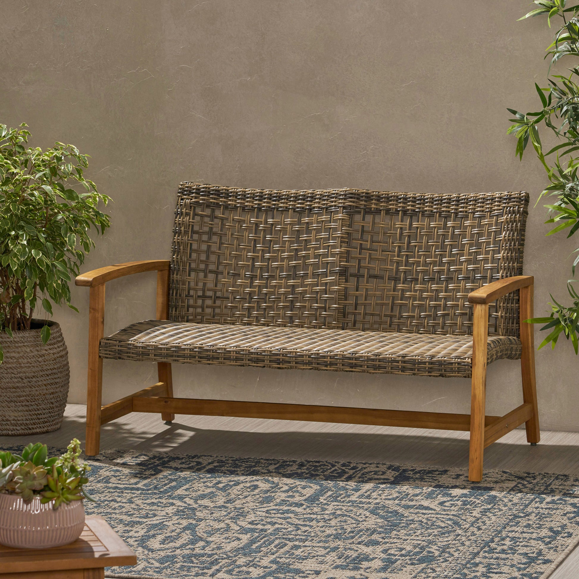 Woven brown rattan loveseat with wooden frame perfect for outdoor patios