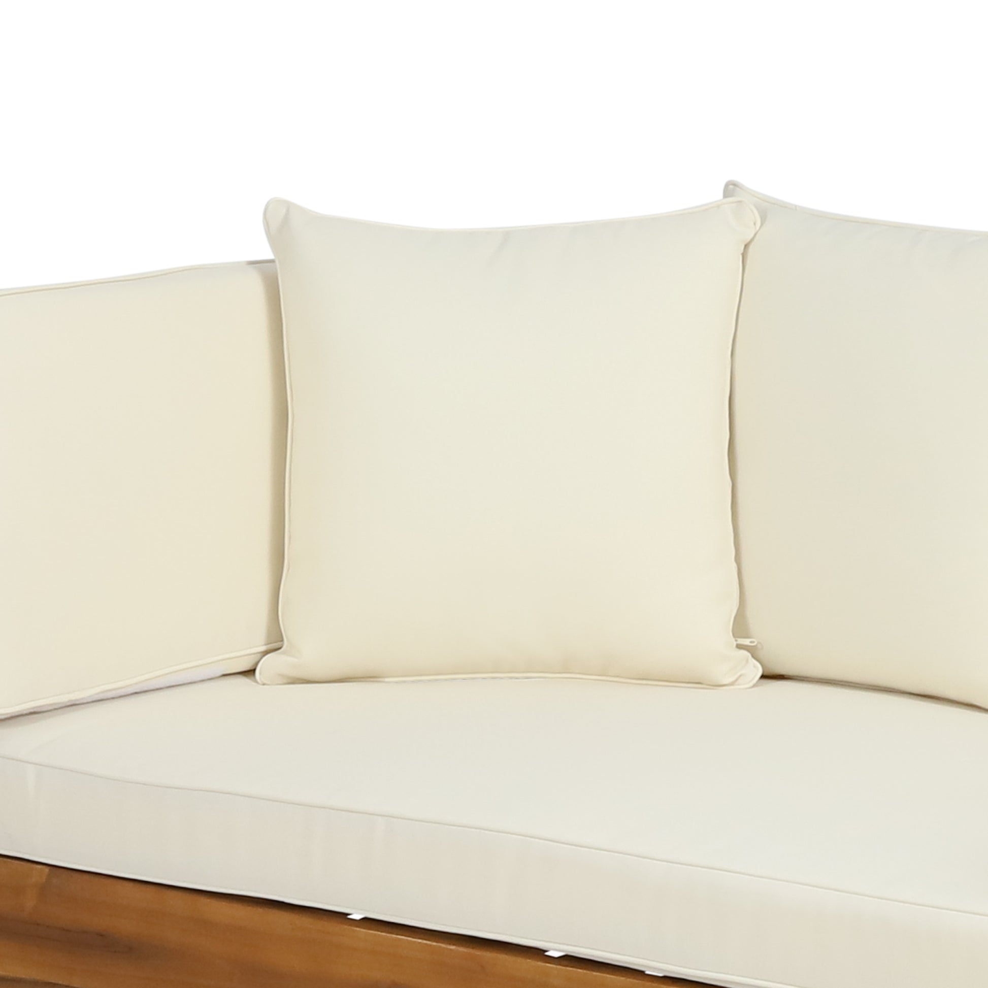 Cream outdoor sofa cushions with piped edges on a wooden base