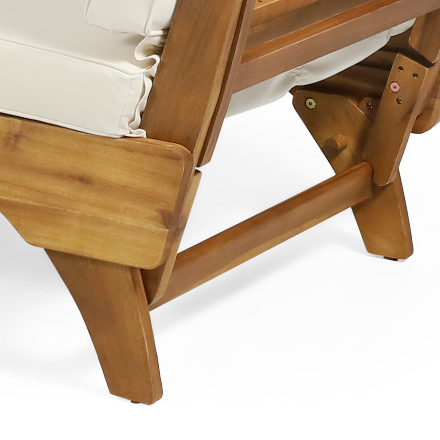 Closeup of a natural wood outdoor chair frame with thick rounded legs and offwhite cushions