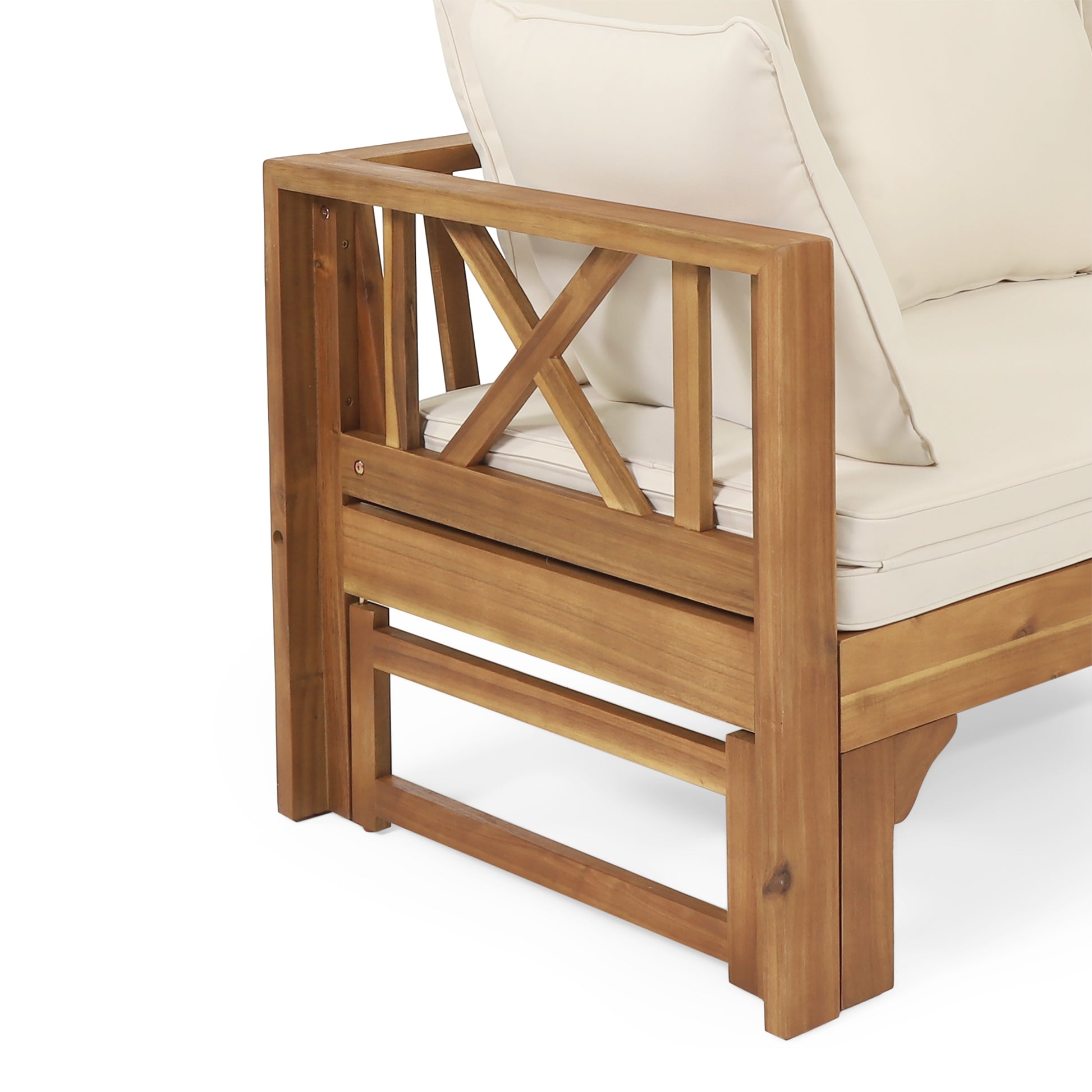 Closeup of a natural wood outdoor sofa armrest with a white cushion and Xshaped detailing