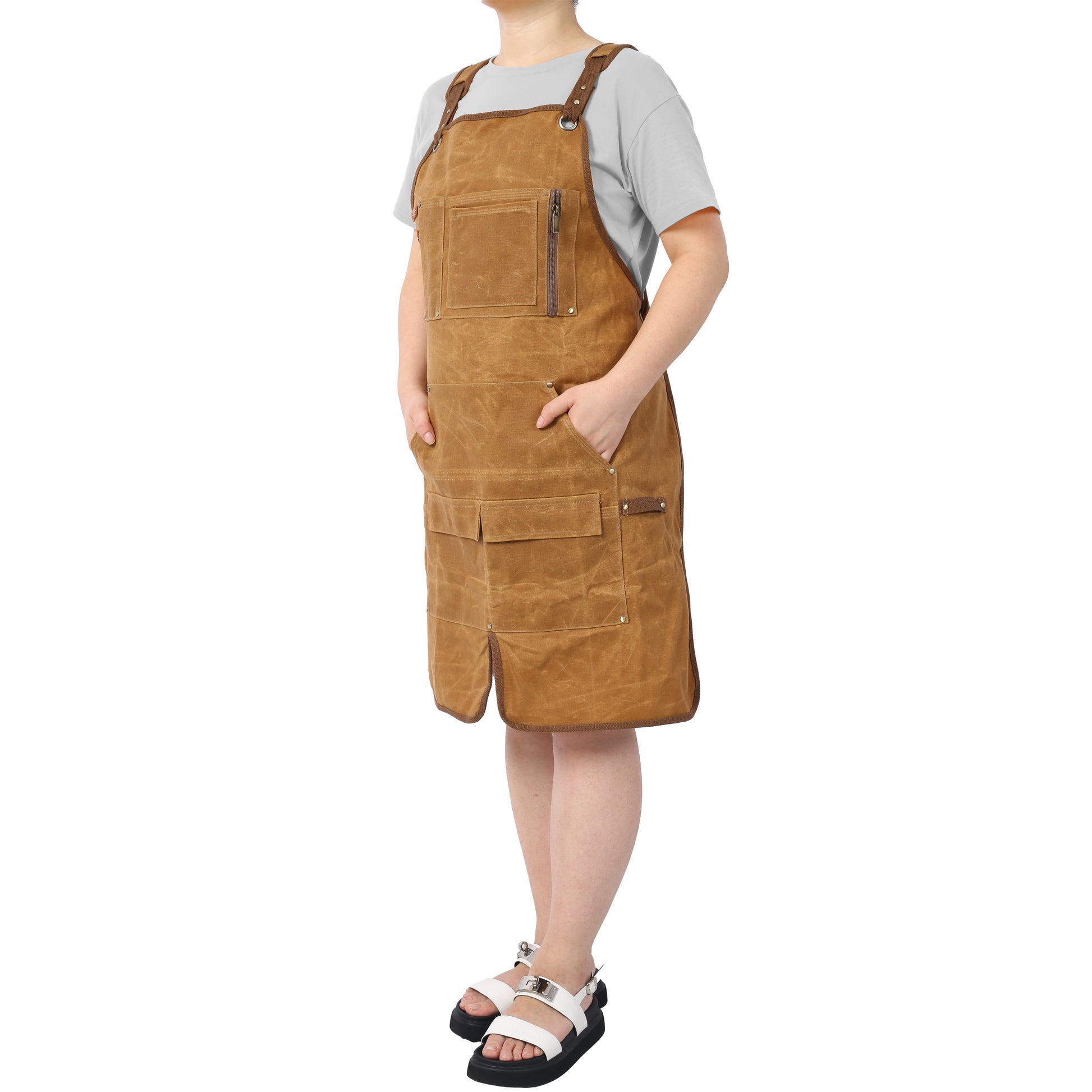 Brown canvas work apron with multiple pockets and leather accents ideal for craftsmen