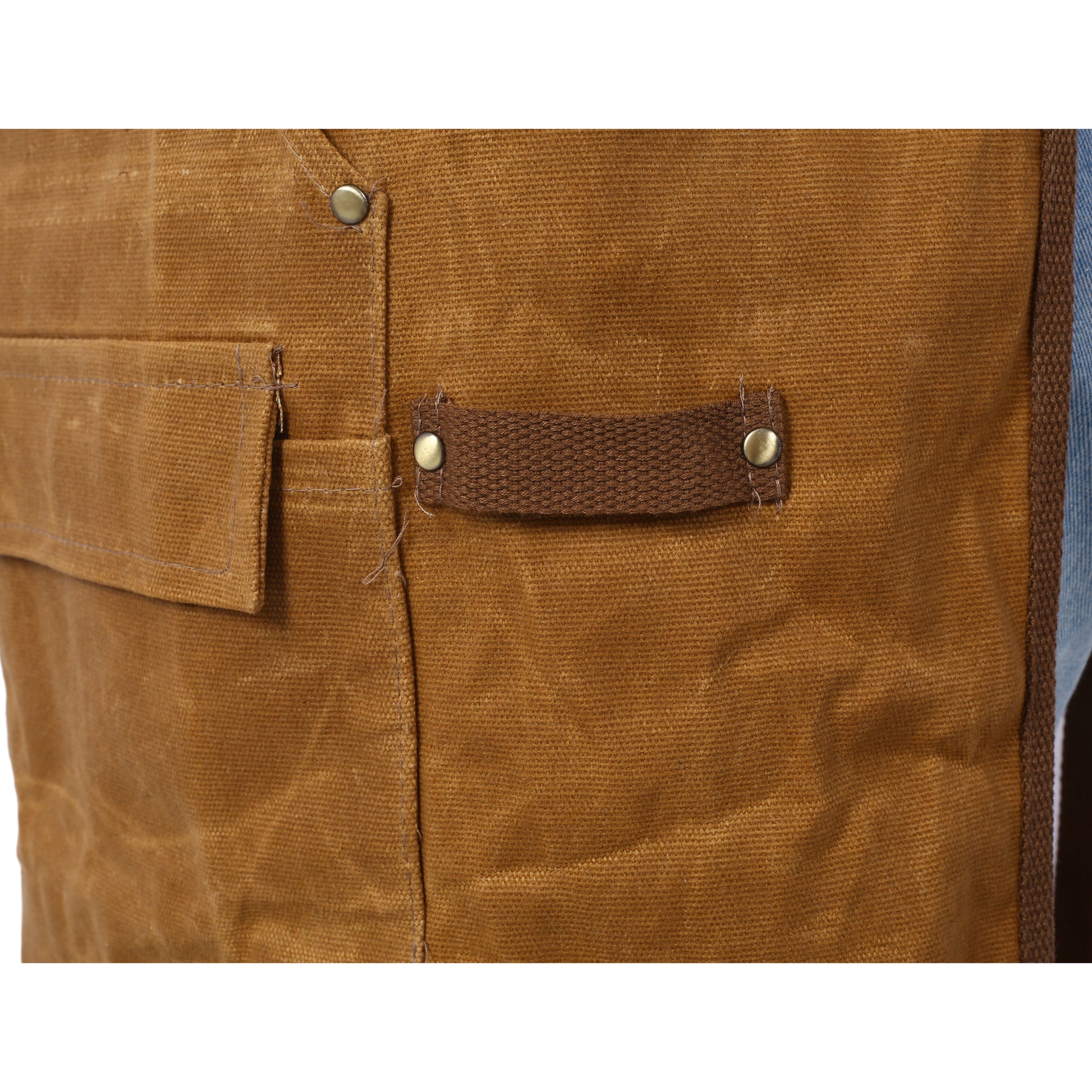 Brown canvas work vest with metal snap closures and a durable utility loop for tools