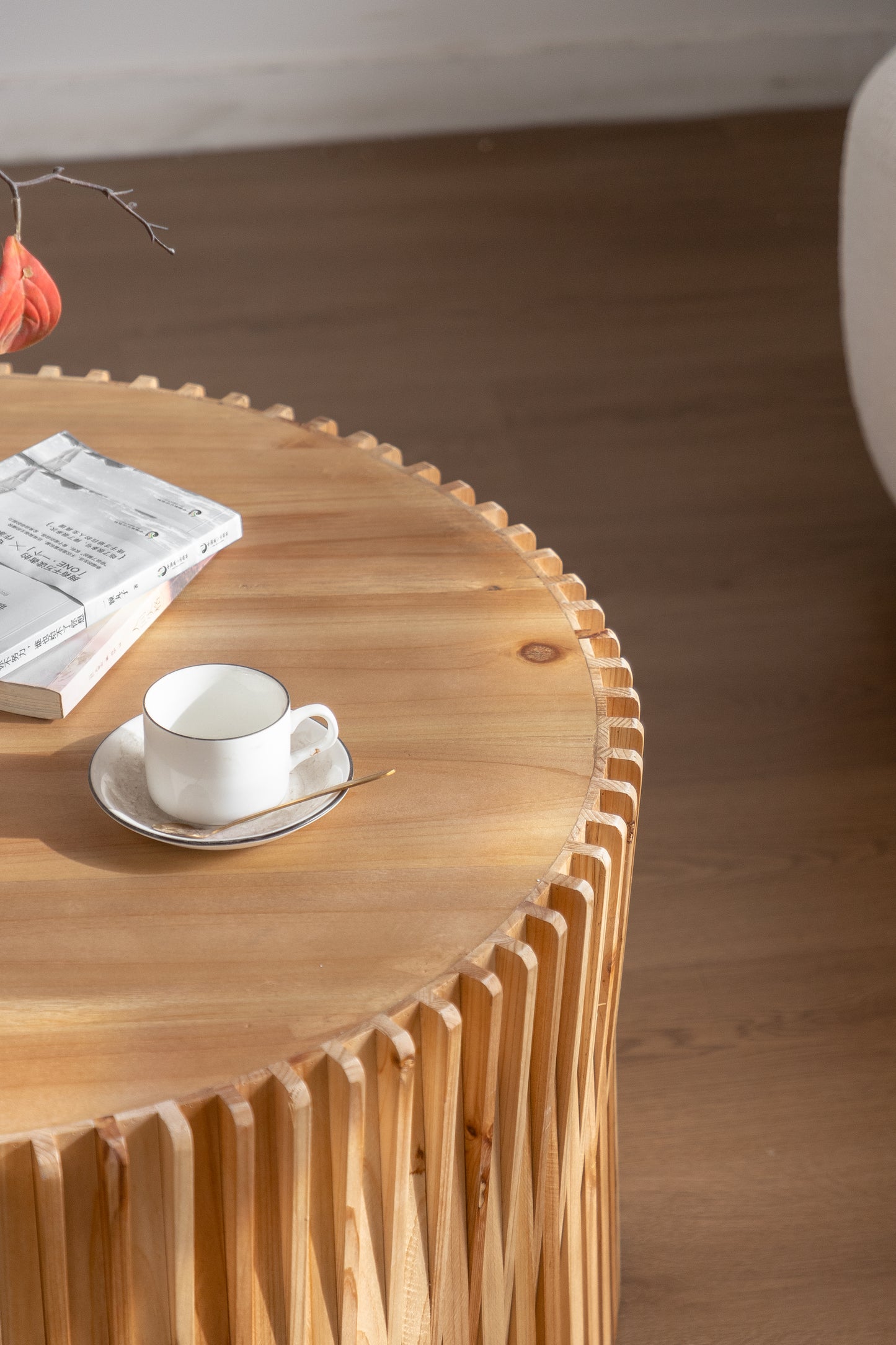 Natural wood coffee table with unique carved legs and a stack of books