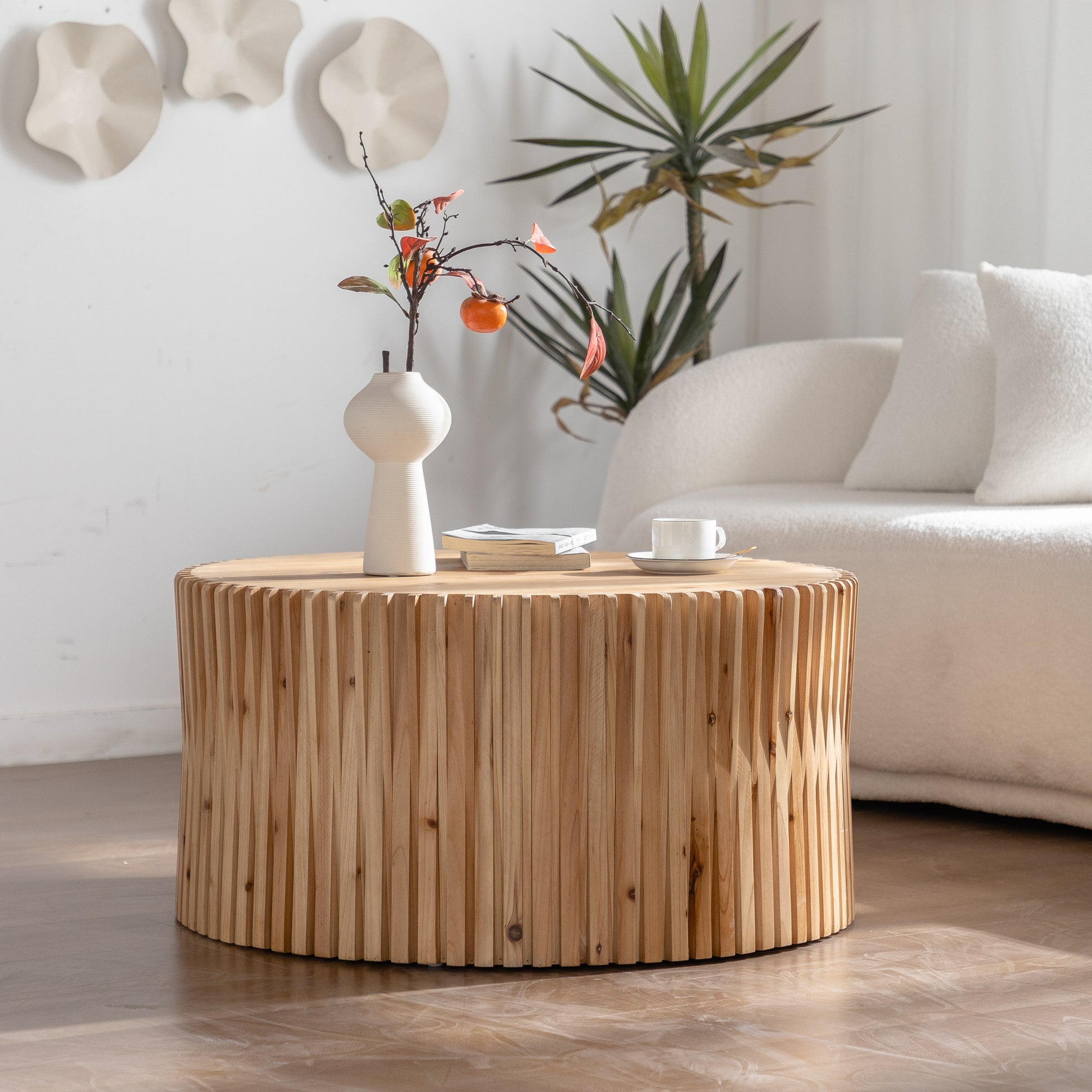 Round wooden coffee table with vertical plank design perfect for modern living room decor