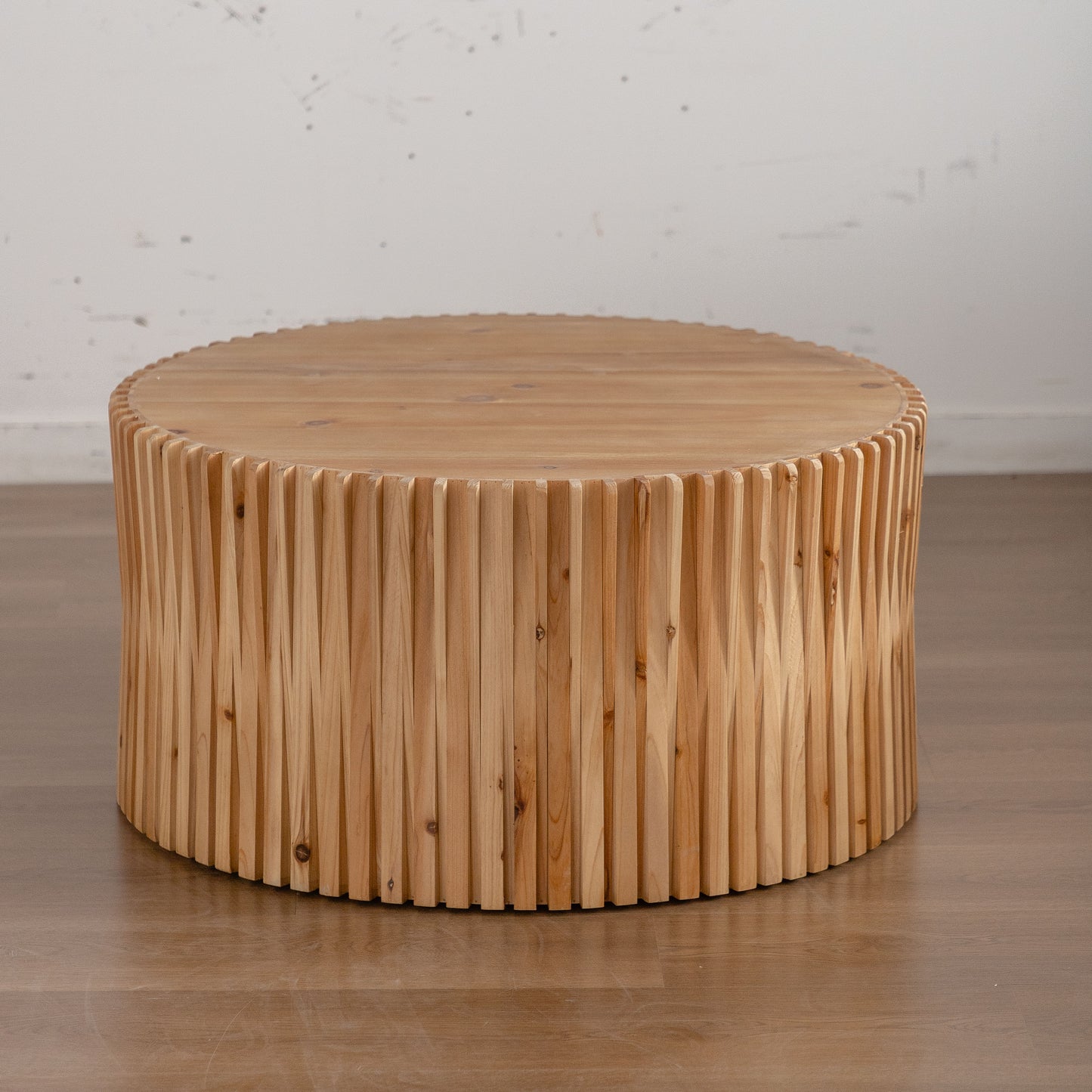 Natural wood coffee table with fluted side detail and smooth round top