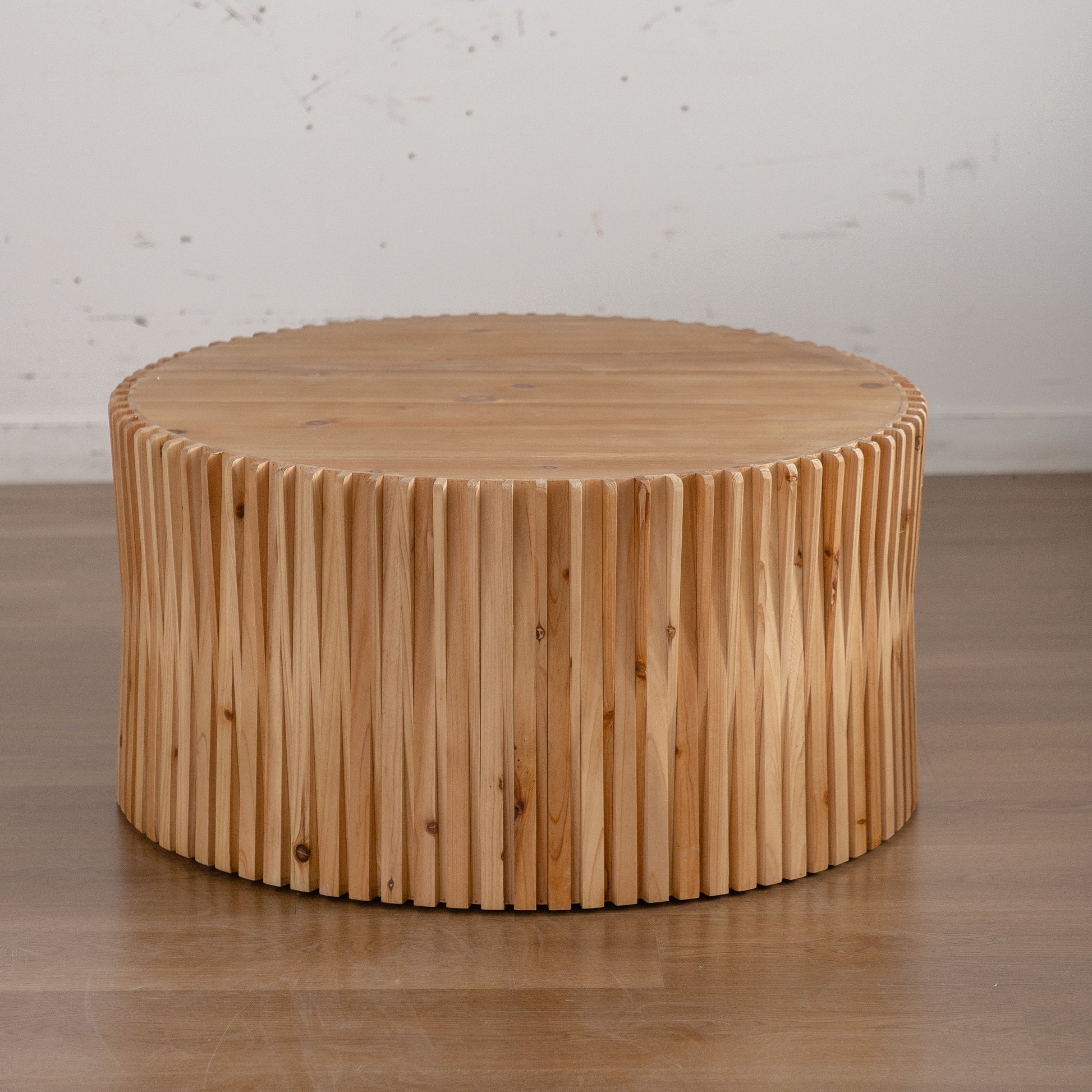 Natural wood coffee table with fluted side detail and smooth round top