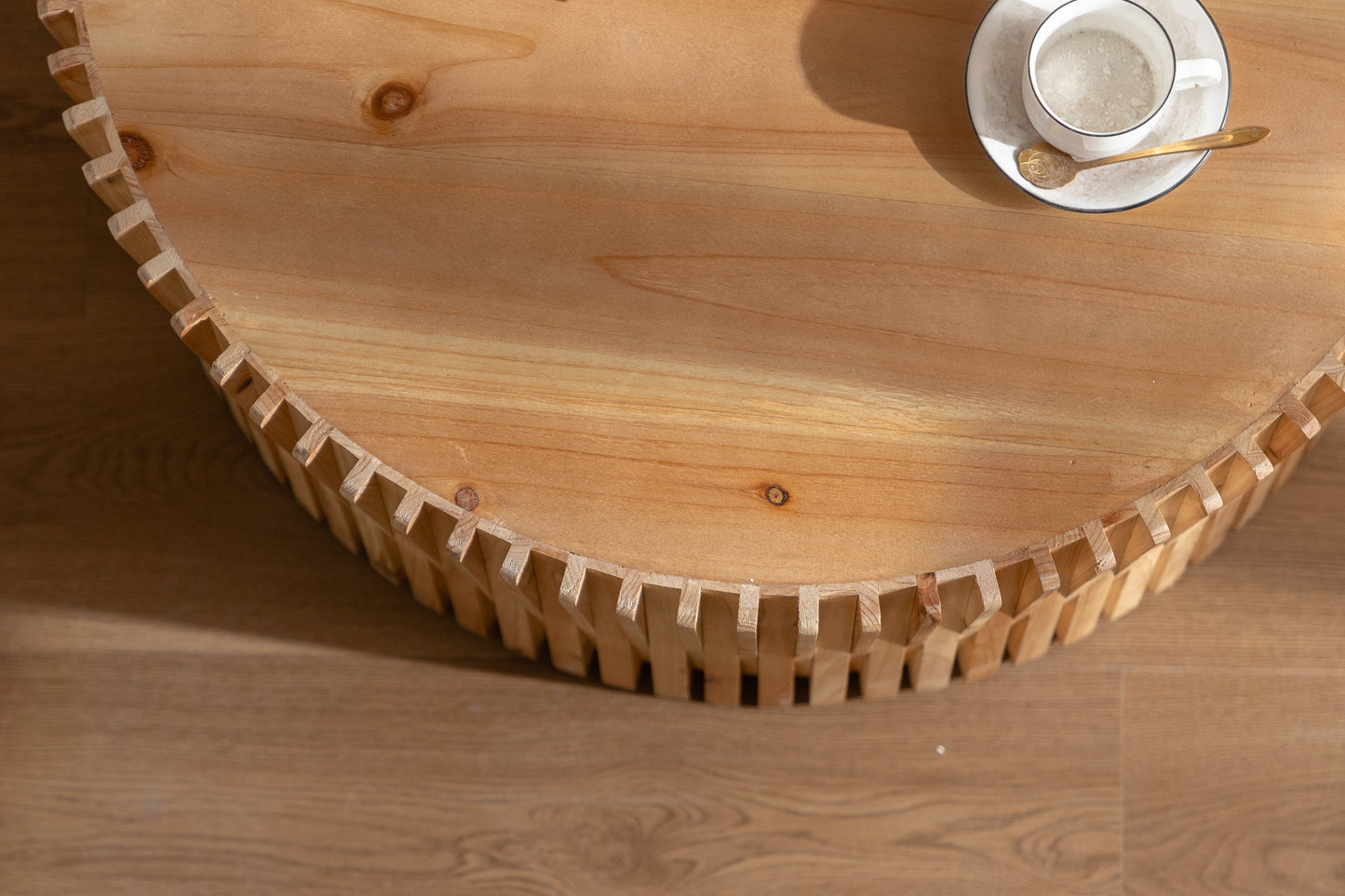 Natural wood coffee table with unique geometric base detail