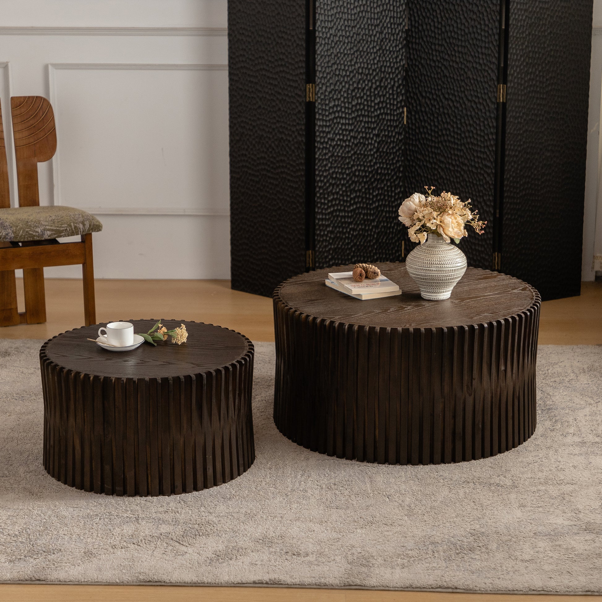 Round wooden coffee table with ribbed dark wood base and textured top