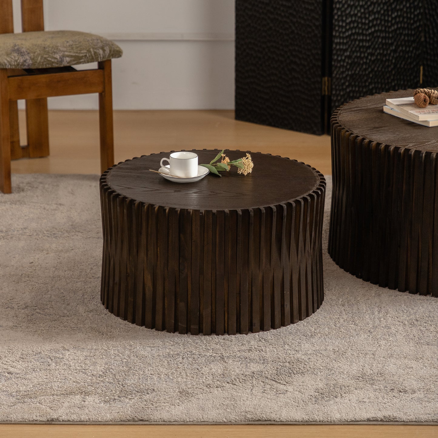 Dark wood drum coffee table with textured vertical slats