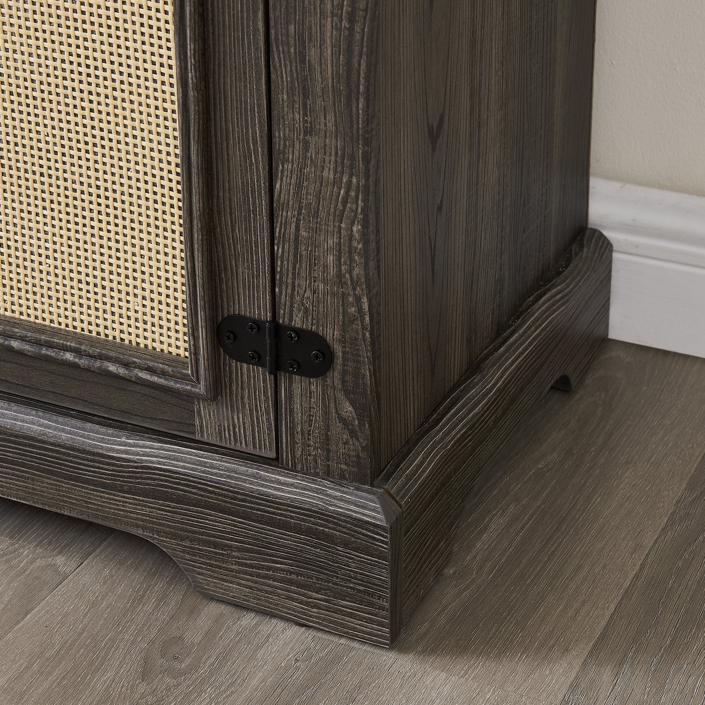 Dark wood cabinet with woven rattan door detail and black metal hinge