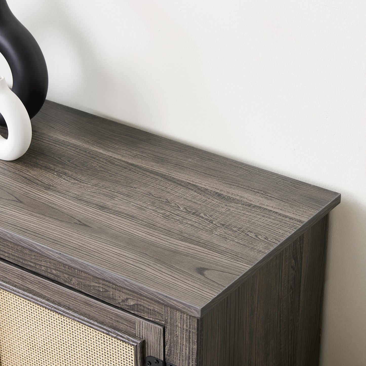 Dark wood grain side table with cane detailing on cabinet door