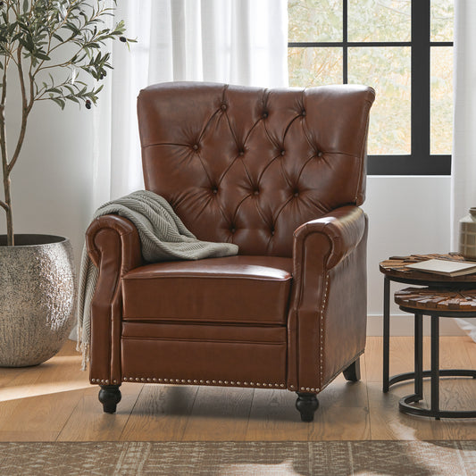 Tufted brown leather recliner chair with silver nailhead trim and a gray throw blanket