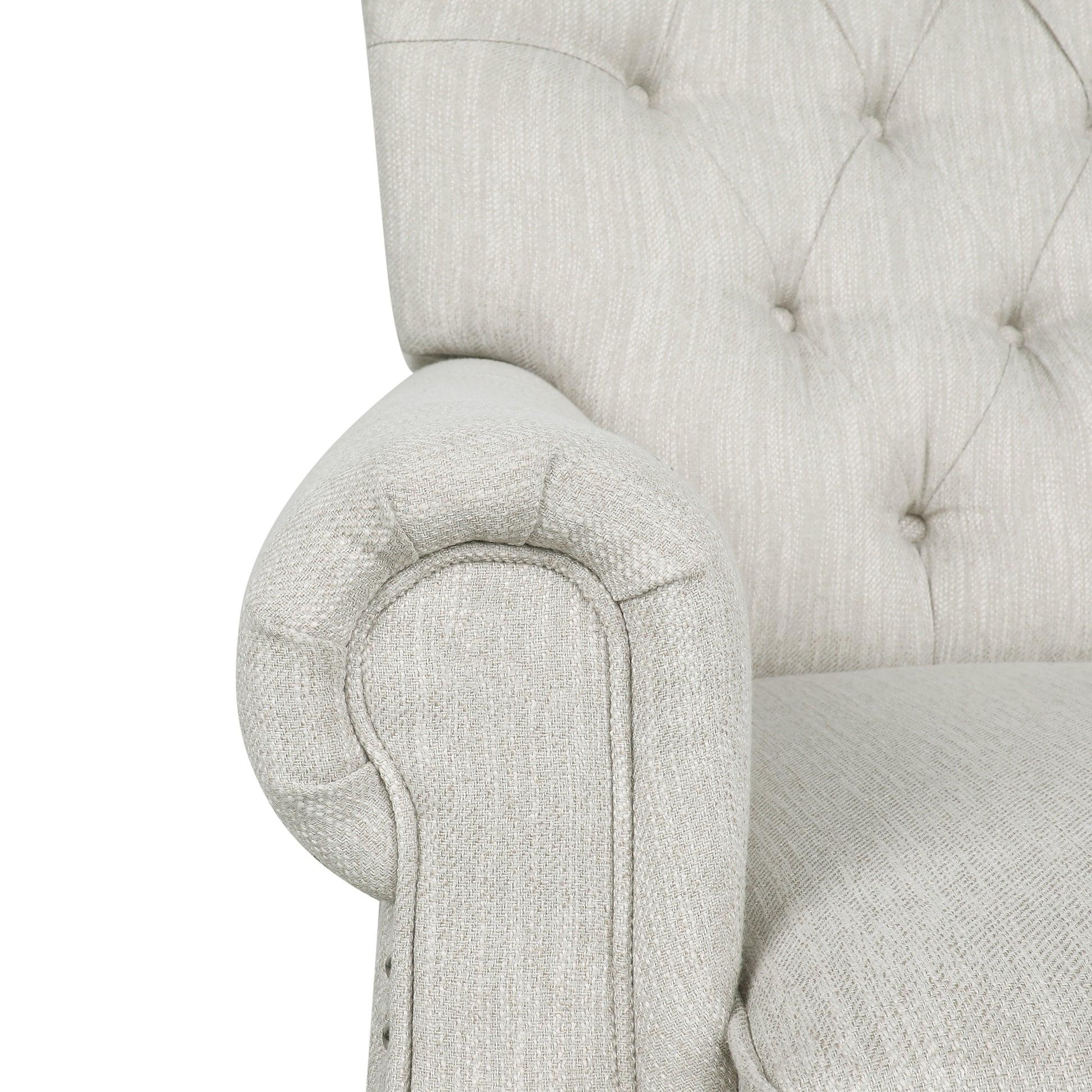 Closeup of a tufted linen armchair armrest in light beige fabric