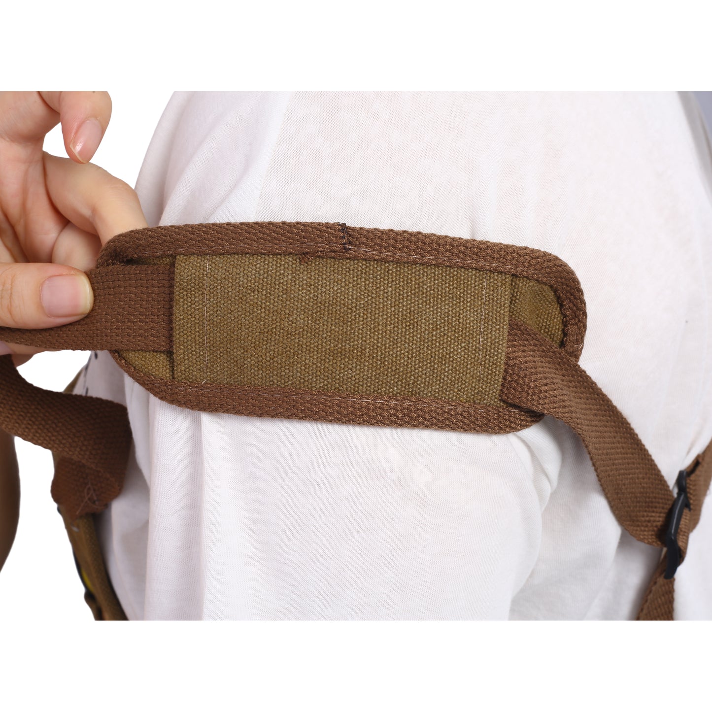 Brown canvas strap padding detail on a white tshirt with hand adjustment
