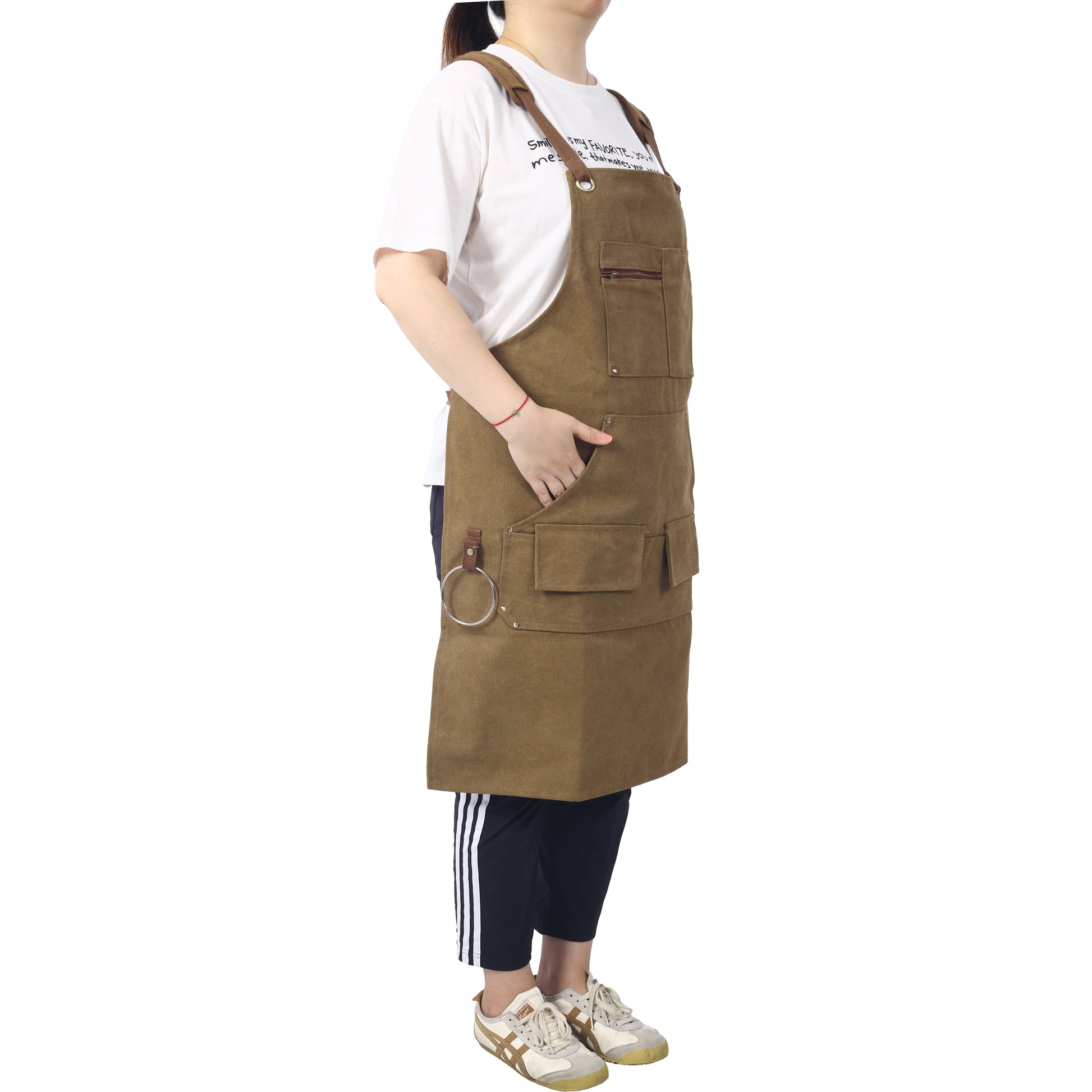 Brown canvas work apron with multiple pockets and a hanging ring for tools