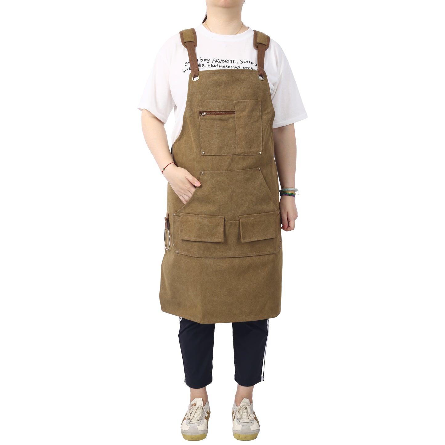 Brown canvas bib apron with multiple pockets and leather straps ideal for work