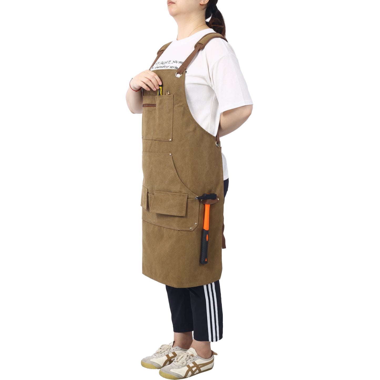 Brown canvas bib apron with multiple pockets for tools ideal for work and crafts