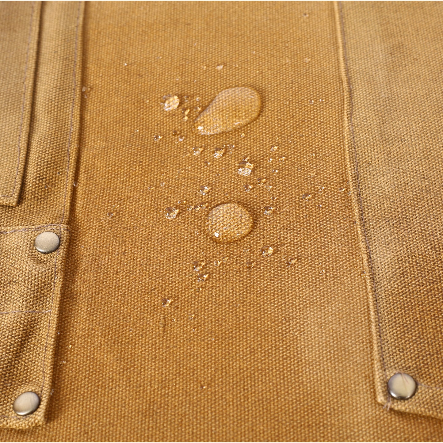 Closeup of water beads on brown canvas fabric highlighting its waterresistant properties