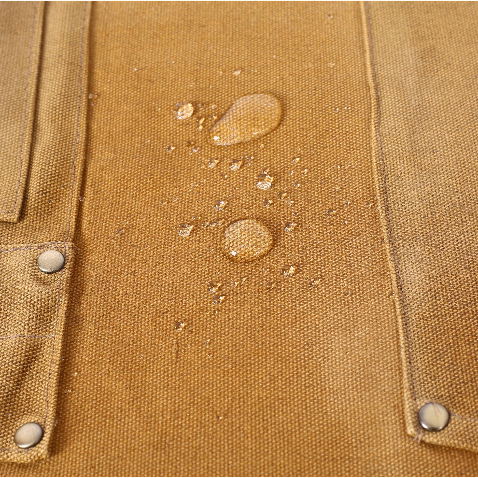 Closeup of water beads on brown canvas fabric highlighting its waterresistant properties