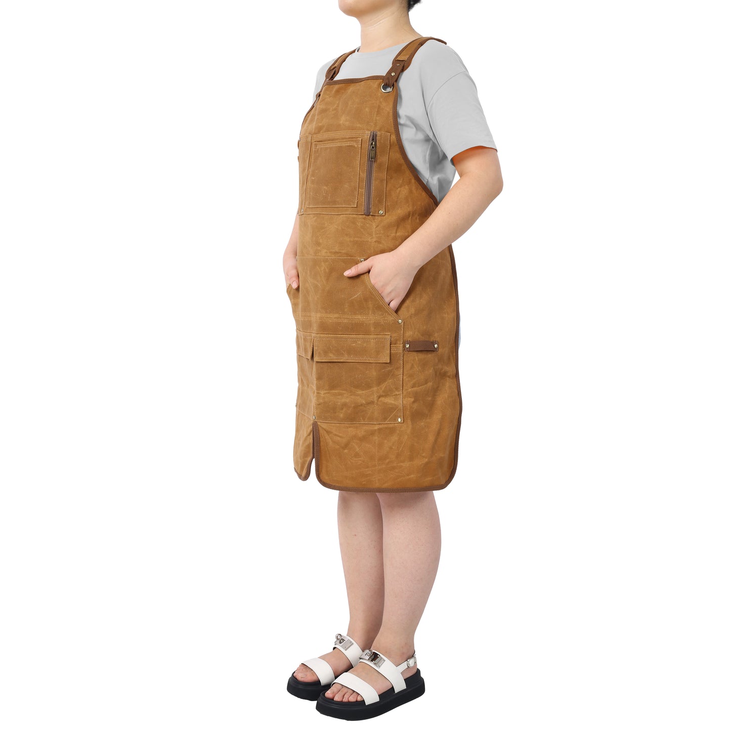 Brown canvas work apron with adjustable straps and multiple pockets ideal for chefs and artisans