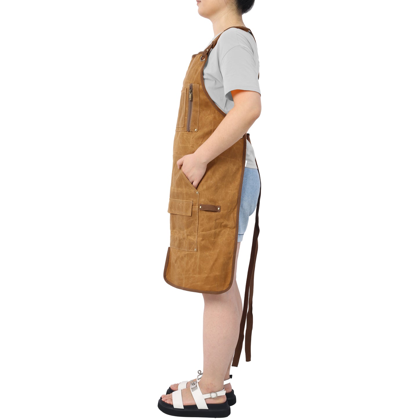 Brown canvas work apron with multiple pockets and zippers for durability