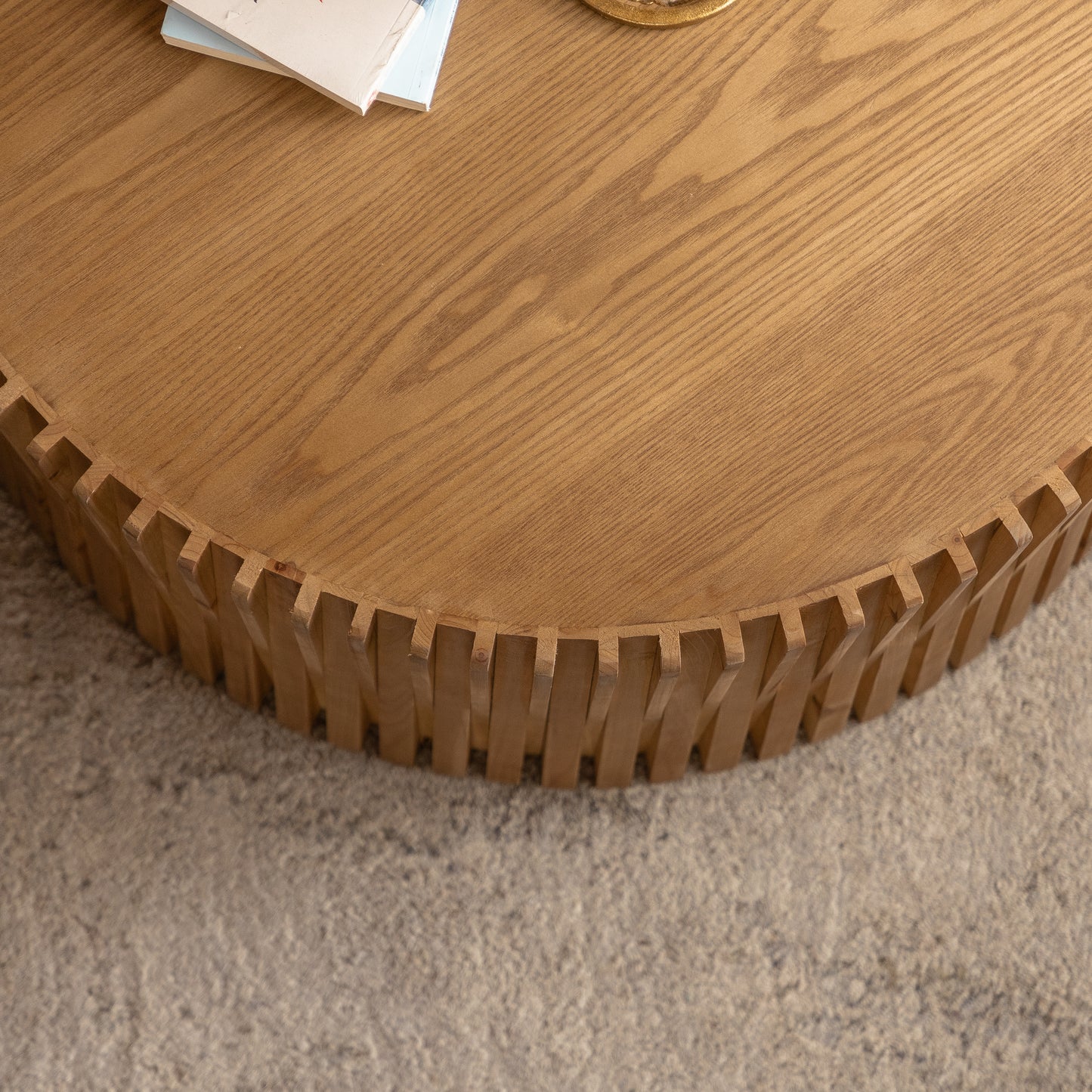 Round wooden coffee table with unique fluted base and natural wood grain finish