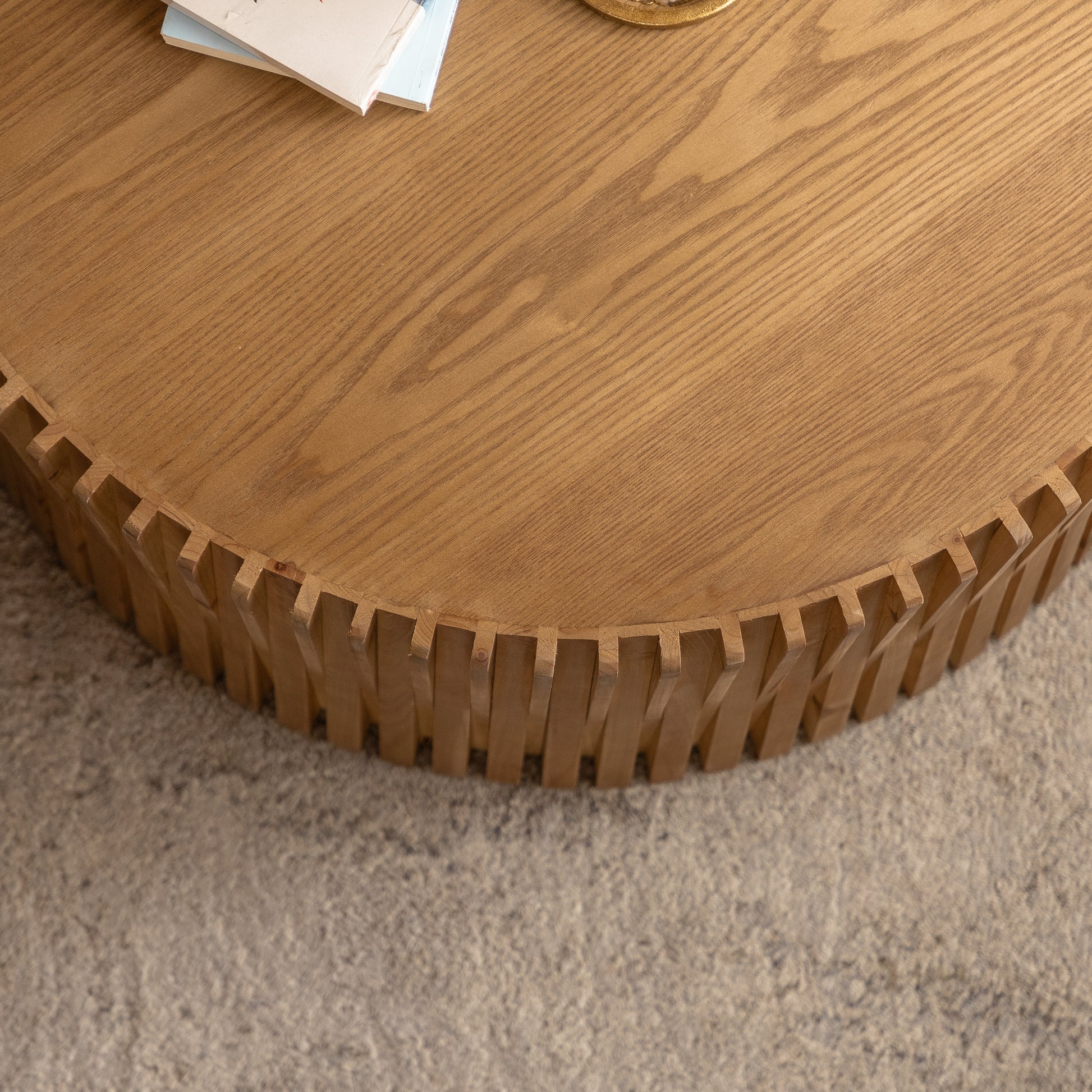 Round wooden coffee table with unique fluted base and natural wood grain finish