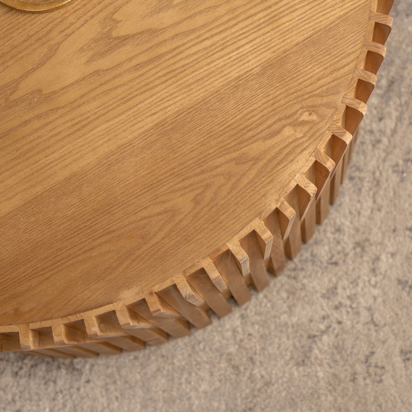 Natural wood coffee table with intricate interlocking joinery on the edge