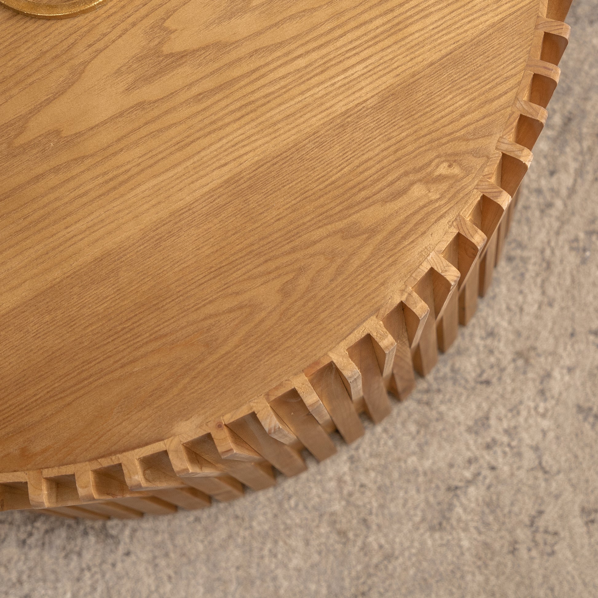 Natural wood coffee table with intricate interlocking joinery on the edge