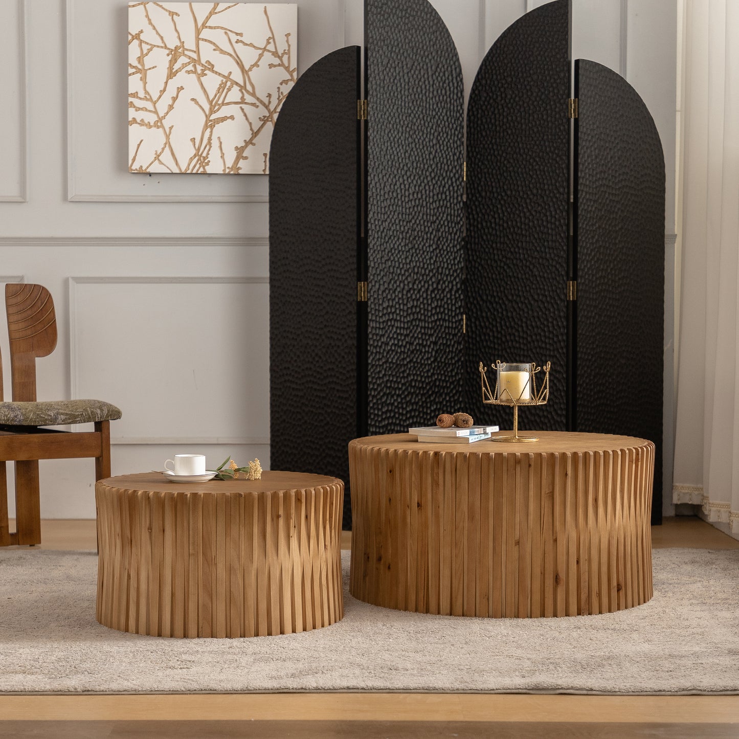 Round wooden coffee table with fluted detail and decorative candle holder