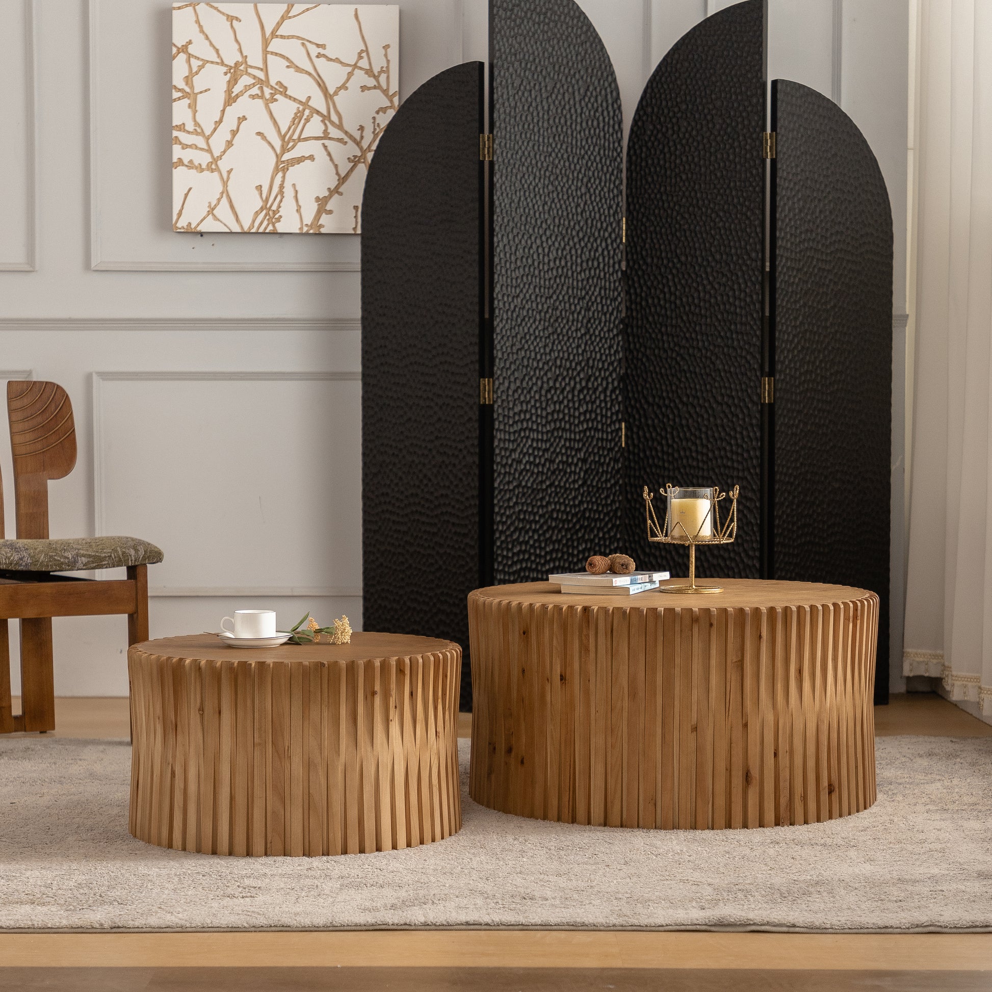 Round wooden coffee table with fluted detail and decorative candle holder