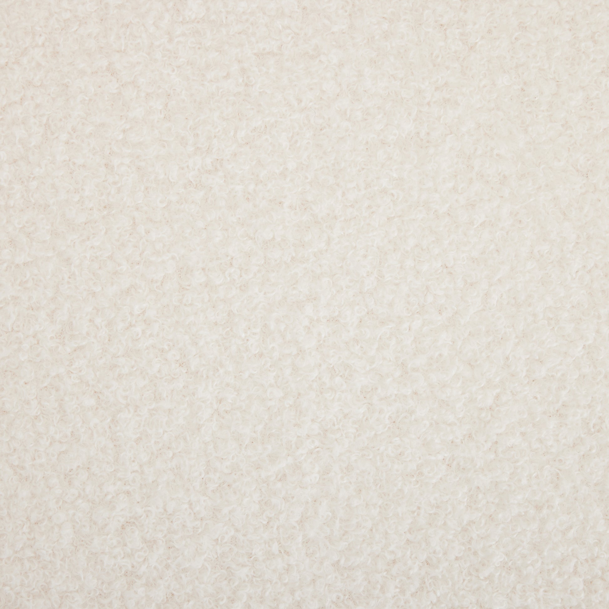 Closeup of ivory boucle fabric with its characteristic looped yarn texture