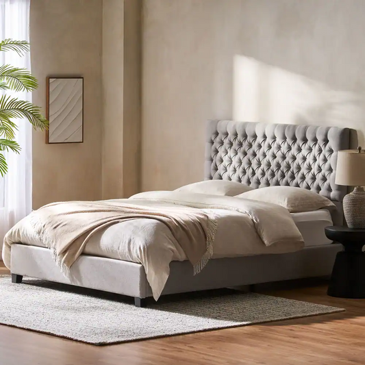 Tufted grey fabric upholstered platform bed with a high diamondstitched headboard