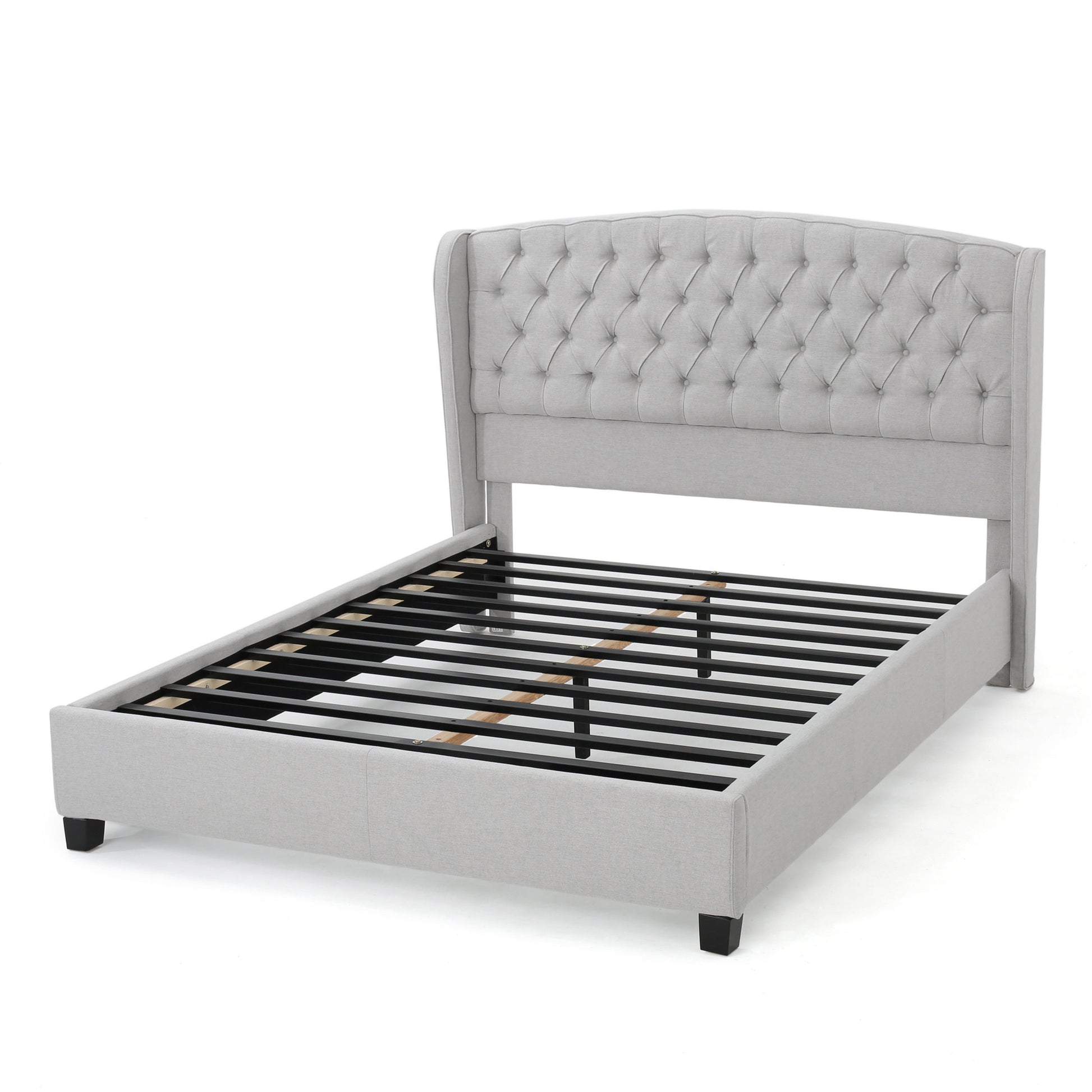 Light gray upholstered bed frame with tufted wingback headboard and metal slats