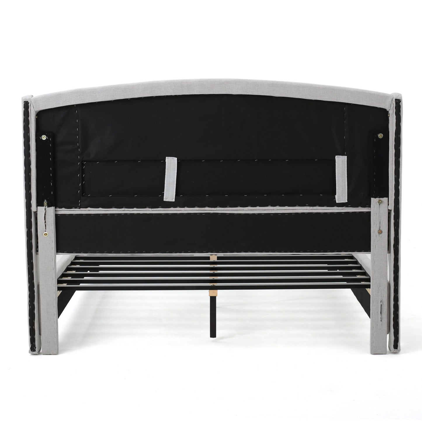 Back view of a grey upholstered bed frame with a slatted base