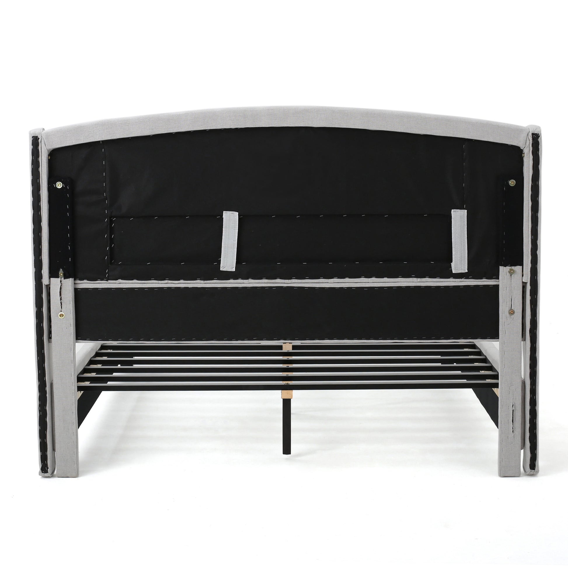 Back view of a grey upholstered bed frame with a slatted base