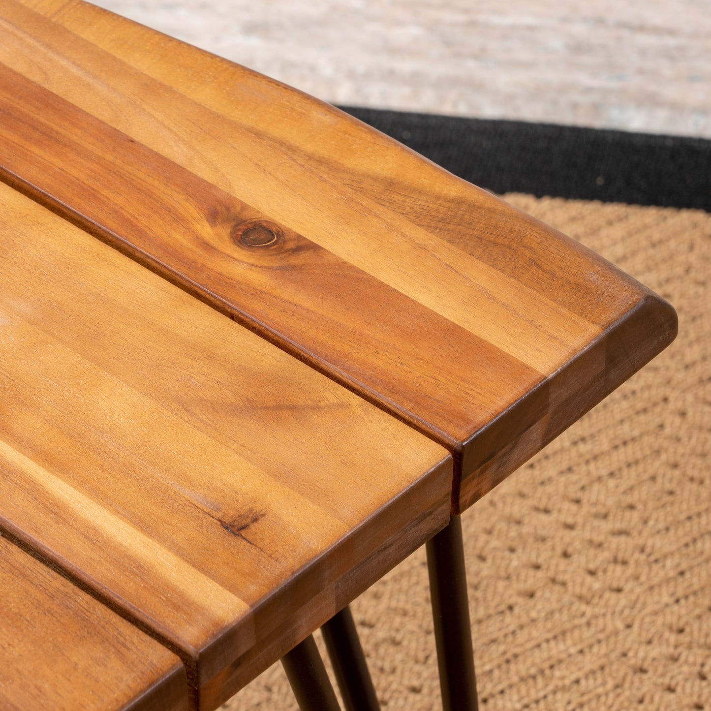 Closeup of a natural wood coffee table with a rich warm finish and visible grain
