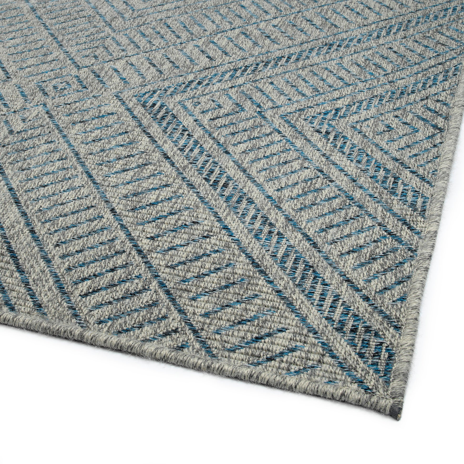 Grey area rug with blue geometric chevron pattern woven texture