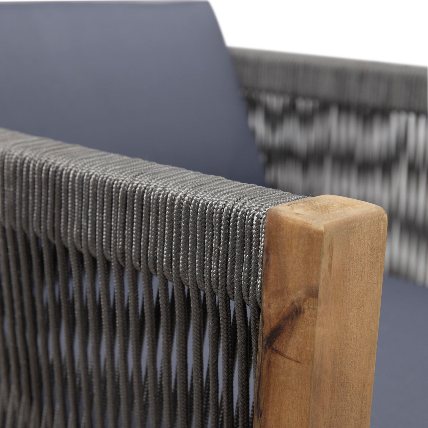 Closeup of grey rope weaving on a woodenframed modern chair with blue cushion
