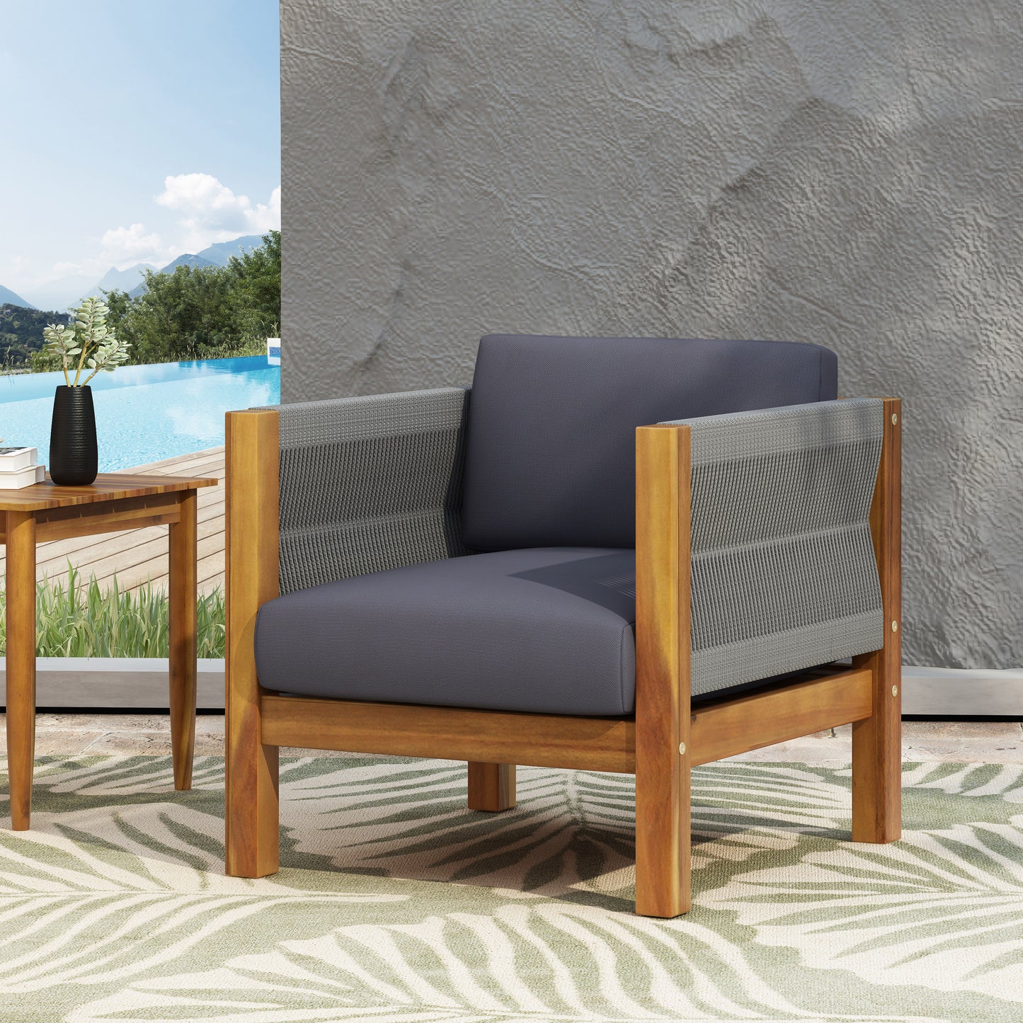 Teak wood armchair with gray woven rope sides and dark gray cushions perfect for outdoor relaxation