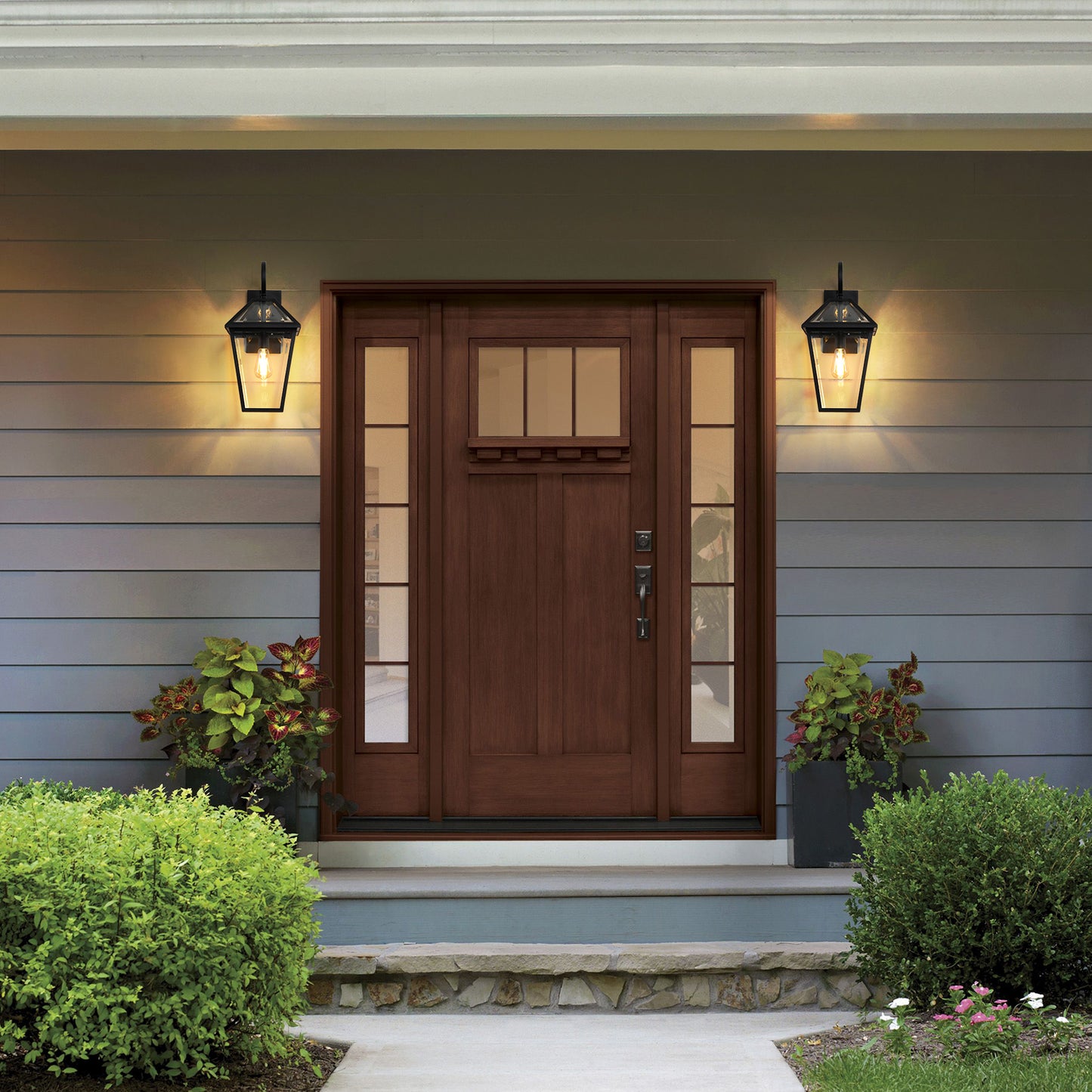Warm cherry wood front door with glass sidelights and transoms inviting entryway